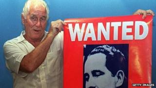 Train-robber Ronnie Biggs holds up his wanted poster in 1994.