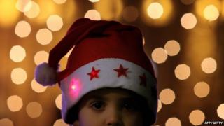 Boy wears santa hat