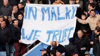 Cardiff fans hold up a flag