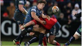 Aled Thomas gets the ball away despite being tackled at Musgrave Park