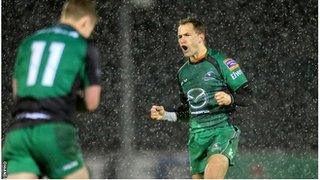 Dan Parks (right) celebrates after landing Connacht's late winning drop goal as snow falls in Galway