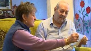 David Spink and wife Astrid examining photos