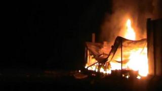A photo reportedly showing burning houses at Camp Liberty in Baghdad