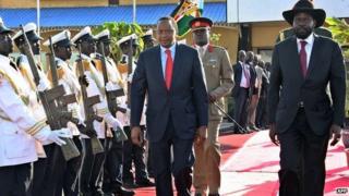 South Sudanese President Salva Kiir (R) and Kenyan President Uhuru Kenyatta (C) reviewing an honour guard during a visit to Juba.