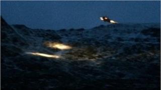 Helicopter hovers over rescue scene