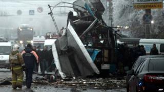 Russian firefighters and security personnel inspect the destroyed trolleybus in Volgograd
