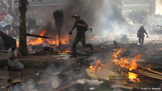 Reporters run for cover during clashes between Muslim Brotherhood supporters of Egypt's ousted president Mohamed Morsi, and police in Cairo on August 14, 2013
