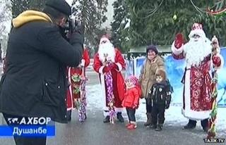 Father Christmasses pose for a photographer