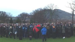 Open air service being held at a cemetery in Craigmillar