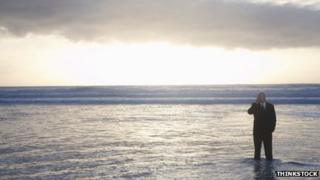 Businessman standing in the sea