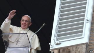 Pope Francis addresses the crowd from the window of the apostolic palace in Vatican City