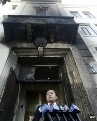 Wang Chuan, spokesperson for the Chinese Consulate, speaks outside of the damaged entrance to the consulate in San Francisco on 2 January 2014