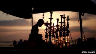 A man prepares hookah pipes