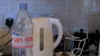 Bottle of water next to a kettle