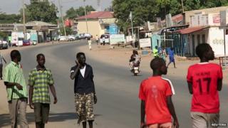 South Sudanese people walk along a street in capital Juba December 16, 201