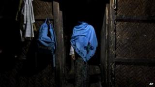 In this 15 September 2013 photo, a woman who claims she was raped by Myanmar security forces stands in her home in Ba Gong Nar village, Maungdaw, northern Rakhine state, Myanmar
