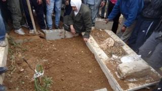 This undated activist photo provided by the group Palestinians of Syria on Monday, Jan. 13, 2014 shows a funeral for a resident who died during the siege of the Palestinian neighbourhood of Yarmouk