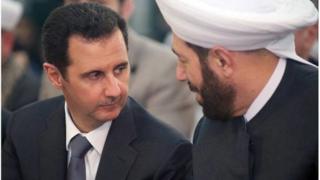 Bashar al-Assad (L) speaking with Syrian Grand Mufti Ahmed Hassun, posted on the government's Facebook page on January 12