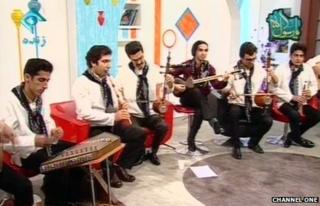 A group of musicians and their instruments on Iranian TV
