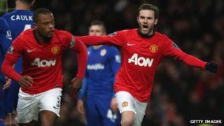 New signing Juan Mata of Manchester United celebrates Robin van Persie scoring against Cardiff