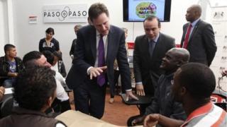 Britain's Deputy Prime Minister Nick Clegg talks with former guerrillas during a visit at a reintegration centre in Bogota