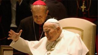 Pope John Paul II with Archbishop Stanislaw Dziwisz as he arrives in the Paul VI hall at the Vatican on 16 October 2003