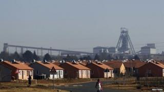A women walks in a Soweto township overlooking the Doornkop Gold Mine, about 30km (19 miles) west of Johannesburg