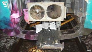 Trolley trapped under train