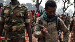 A government soldier puts his knife away after allegedly taking part in the lynching in Bangui. Photo: 5 February 2014