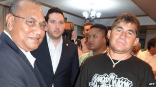 Jose Salvador Alvarenga (R) of El Salvador shakes hands with Marshall Islands President Christopher Loeak prior to his departure at the airport in Majuro on February 10, 2014.