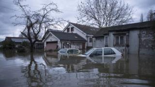 house and car under floodwater