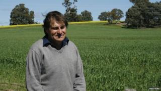 File photo: West Australian organic farmer Steve Marsh at the fence line of his property and his neighbour Michael Baxter's genetically-modified canola farm in Kojonup, 10 September 2011