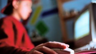 Teenage boy using a personal computer