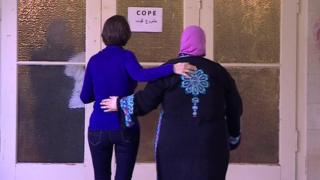 Ruth Ebenstein and Ibtisam Erekat enter a COPE breast-cancer support meeting in Jerusalem