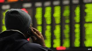 An investor looking at stock boards