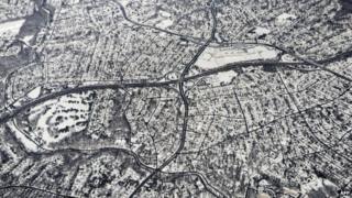 Snow is seen on the ground in northern Virginia from Air Force One as it flies to California 14 February 2014