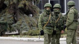 Unidentified armed men patrol in front of the airport in Simferopol, Ukraine, on 28 February 2014