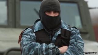 A masked pro-Russian militant stands with his arms crossed in front of a truck in Crimea on 4 March.