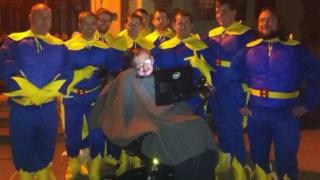 Chris Hallam and friends dressed as Bananaman with Prof Stephen Hawking