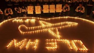 International school students light candles to pray for passengers aboard Malaysia Airlines flight MH370, in Zhuji, Zhejiang province, March 10, 2014.