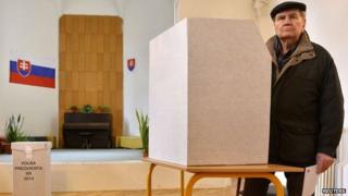 A man prepares to cast his ballot at a polling station during the first round presidential elections in Bratislava March 15, 2014.