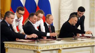 Crimean leader and President Putin sign the deal