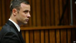 South African Paralympic athlete Oscar Pistorius waits on day 10 of his murder trial at the North Gauteng High Court in Pretoria, on 14 March 2014