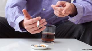 Man smoking and drinking alcohol