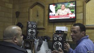 People listen to the speech by Abdul Fattah al-Sisi declaring his candidacy for the Egyptian presidential election, in a public cafe in Cairo