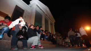 People sit outside after tsunami alert in Chile