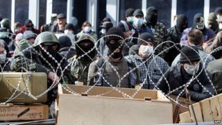Pro-Russian activists guard a barricade set at the Ukrainian regional Security Service building on the eastern city of DonetskPro-Russian activists guard a barricade set at the Ukrainian regional Security Service building on the eastern city of Donetsk