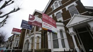 Houses with for sale boards outside
