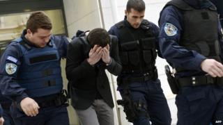 Police with one of those arrested over murder of Pakistani (18 December 13)
