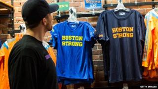 A man looks at "Boston Strong" t-shirts on display at a store.